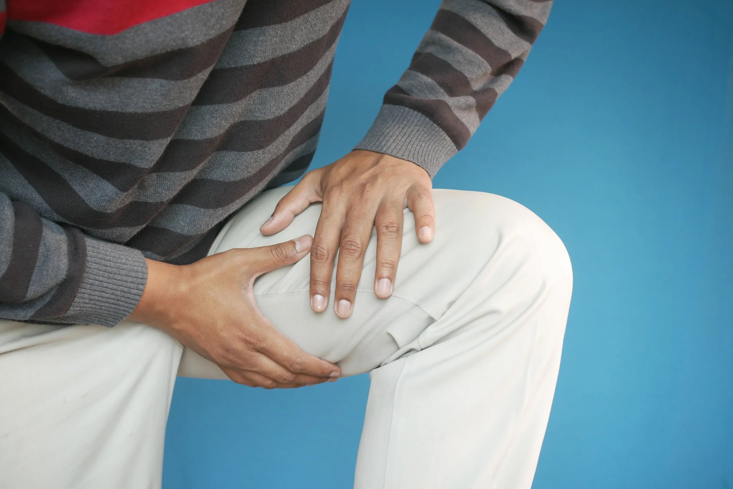 3. Adult carefully testing movement in a replaced knee that now feels stiffer